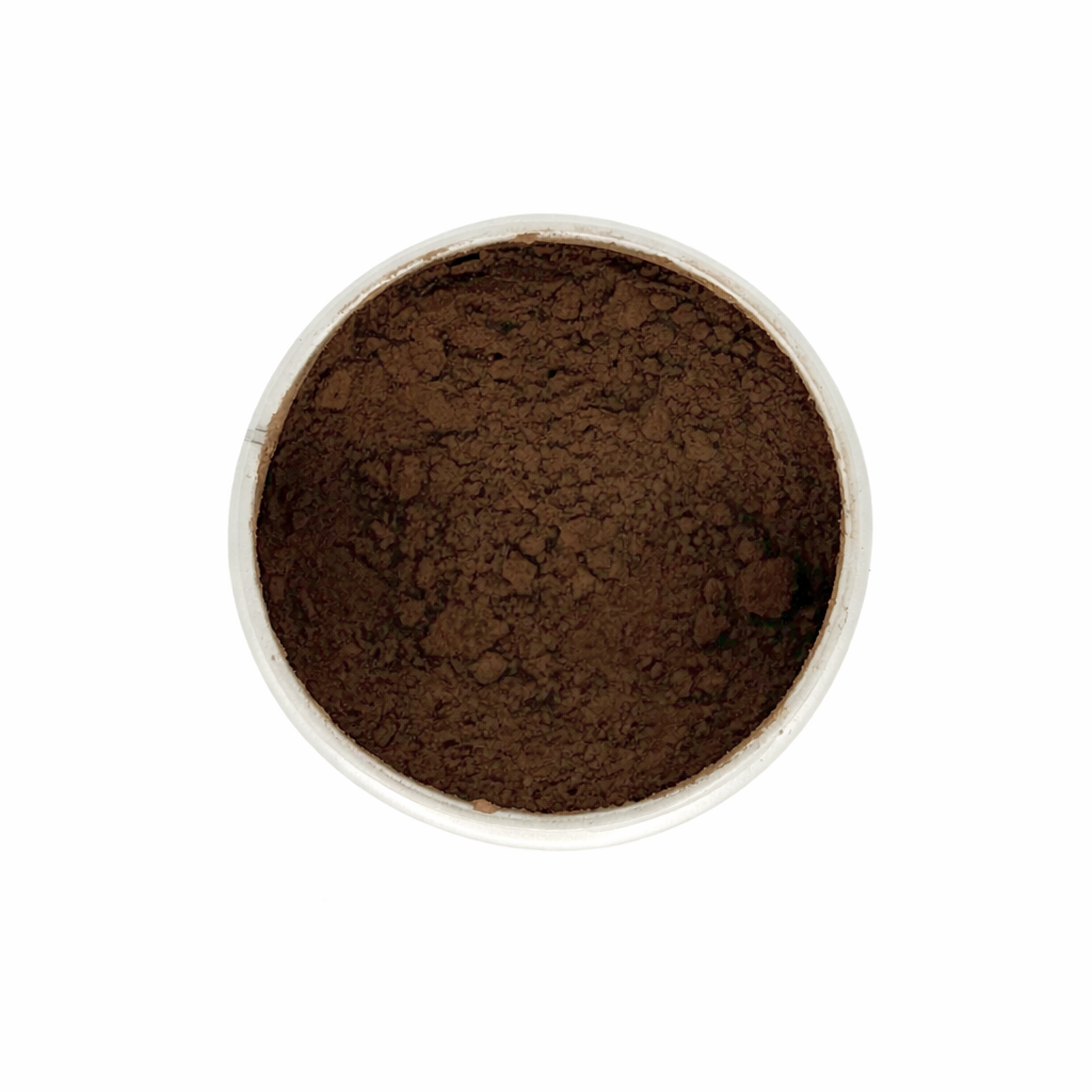 Brown hojicha powder in a white container on a white background